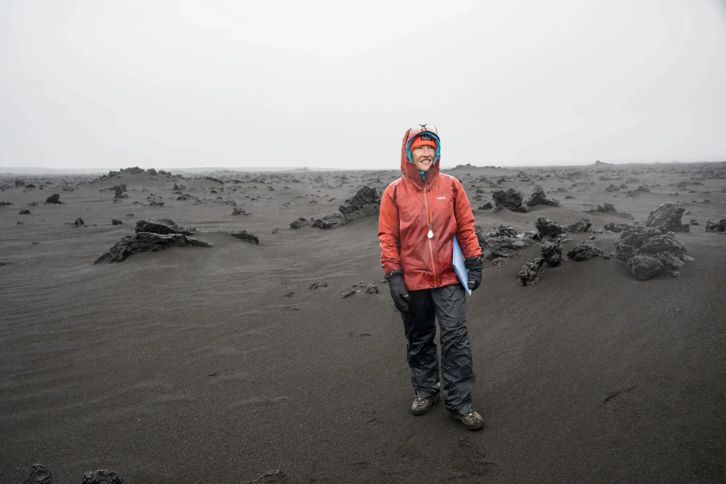 NASA astronaut Christina Koch stands in a desolate, rocky landscape during geology field training in Iceland.