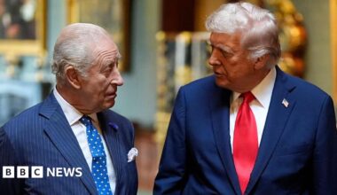 King Charles and President Trump during the state visit in September. They are talking to each other, both wearing blue suits and ties