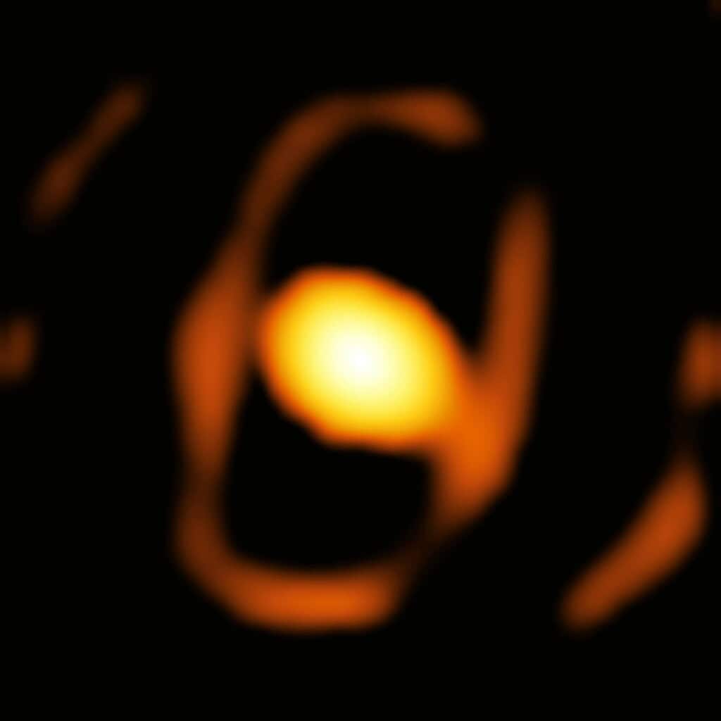 Blurred image of a star with bright core and fiery outer layers.