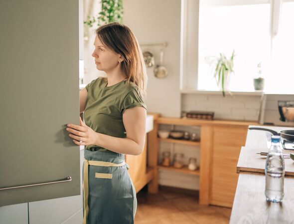 Young woman in front of fridge