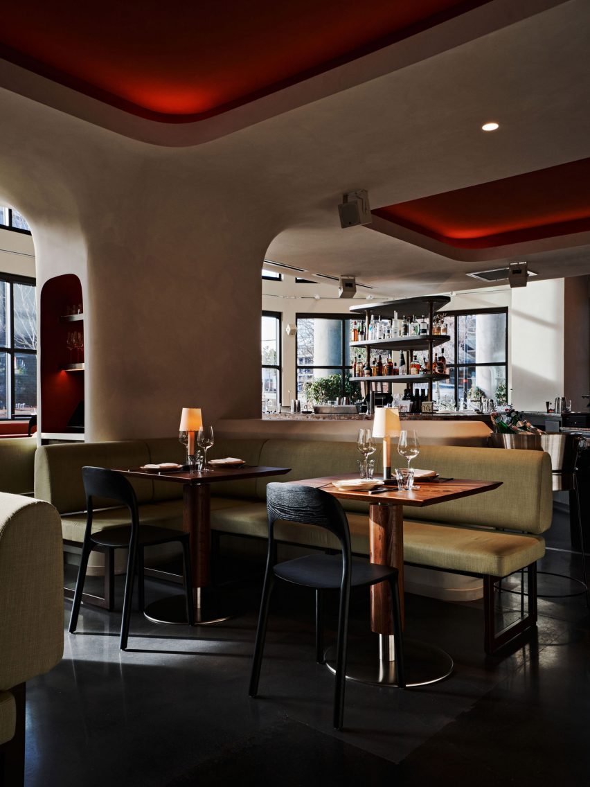 Limewashed elements curve over structural columns and soften angles