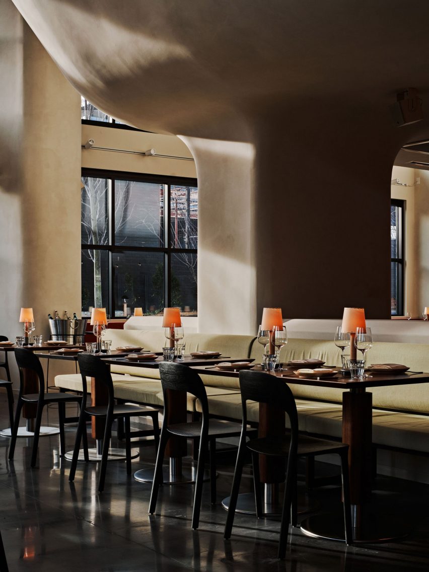 Pistachio fabric covers seats in an intimate dining area