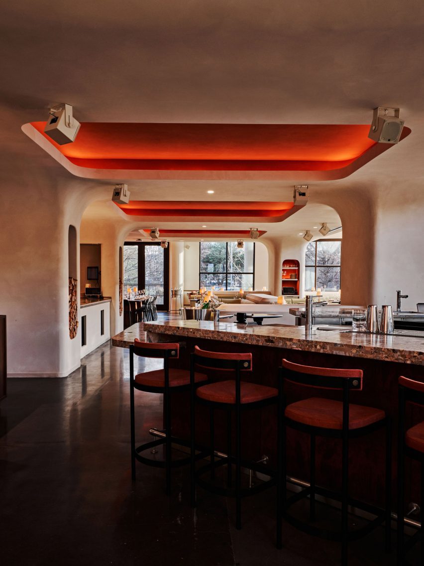 Paprika-toned ceiling insets glow thanks to cove lighting