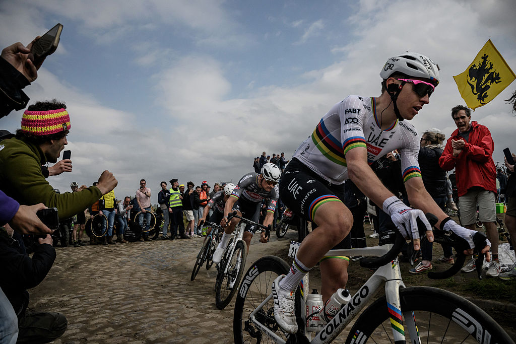 Alpecin-Deceuninck's Belgian rider Jasper Philipsen (L), Alpecin-Deceuninck's Dutch rider Mathieu van der Poel and UAE Team Emirate's Slovenian rider Tadej Pogacar (R) cycle in a breakaway on a cobblestone road during the 122nd edition of the Paris-Roubaix one-day classic cycling race, 259,2 km between Compiegne and Roubaix, northern France on April 13, 2025. (Photo by JEFF PACHOUD / AFP)