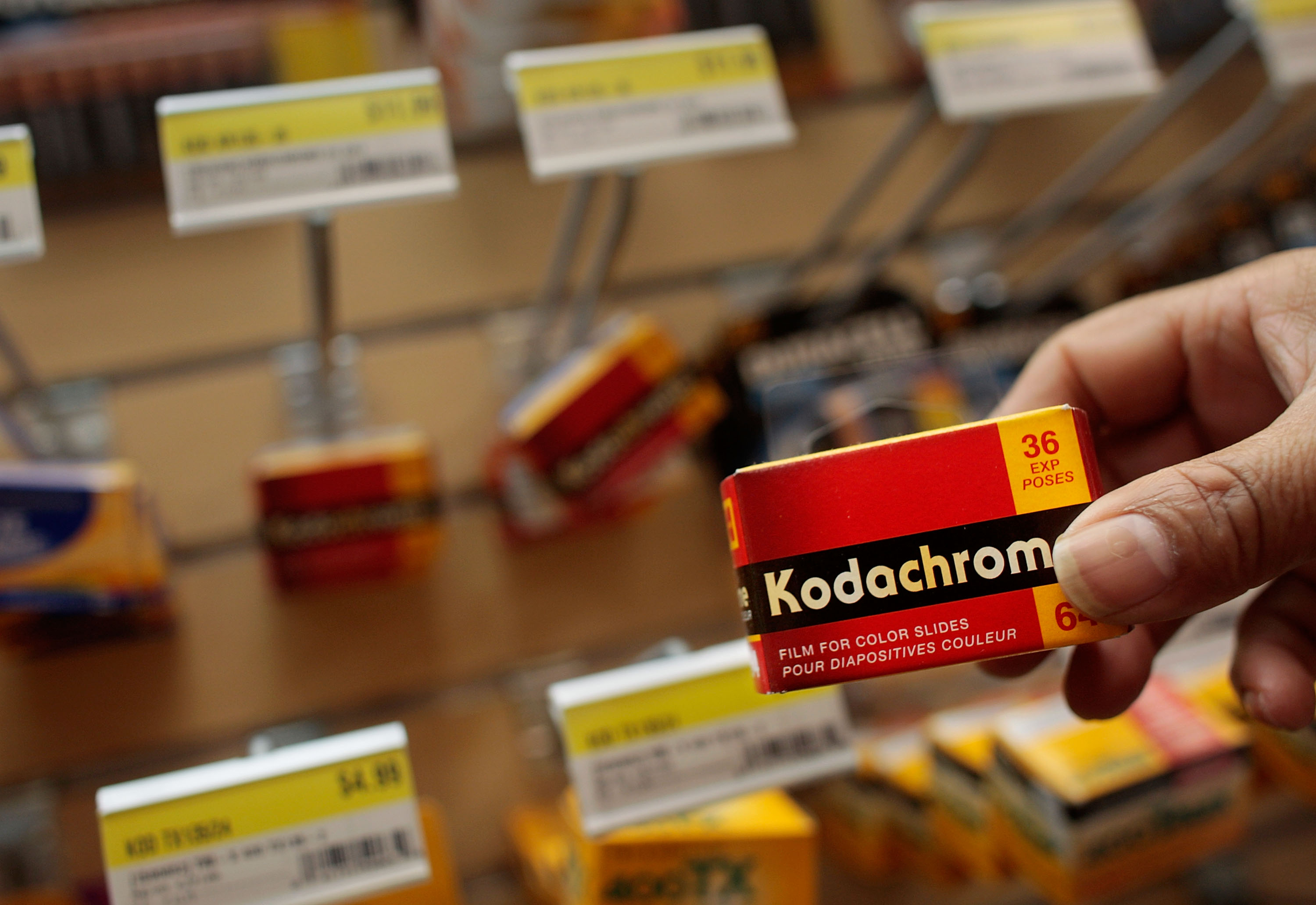 Kodachrome film box being held in someone's hand in a camera store
