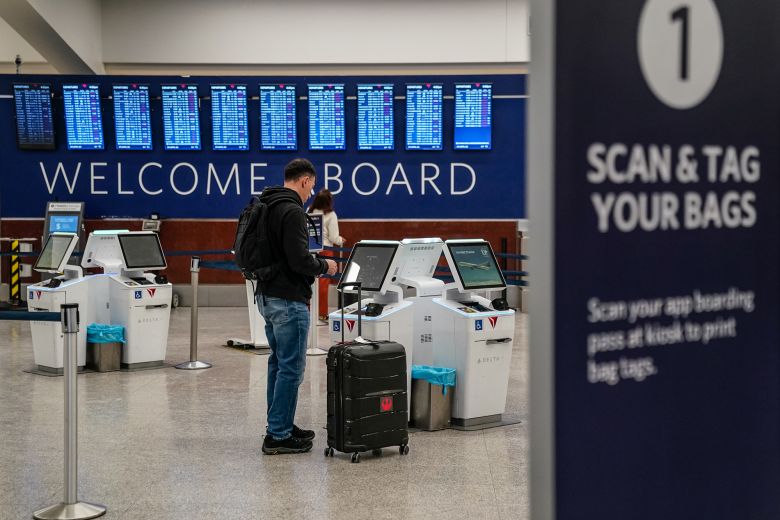 A passenger is seen at a Delta Airlines check-in kiosk at Hartsfield-Jackson Atlanta International Airport on January 25, 2026 in Atlanta, United States.