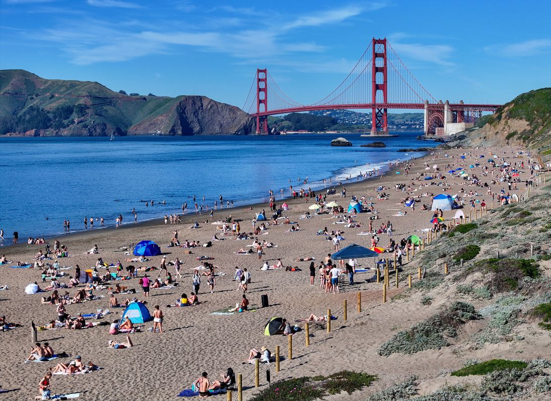 People flock Baker Beach near the Golden Gate Bridge as heat advisory issued in San Francisco, California, on March 16.