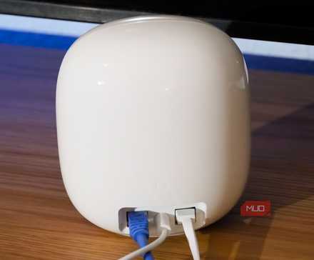 Ethernet and power cables plugged into the Nest Wi-Fi Pro.