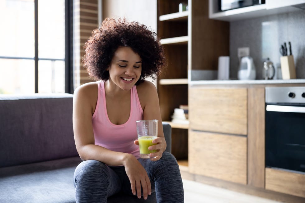 Healthy woman drinking a green smoothie healthy woman drinking a green smoothie