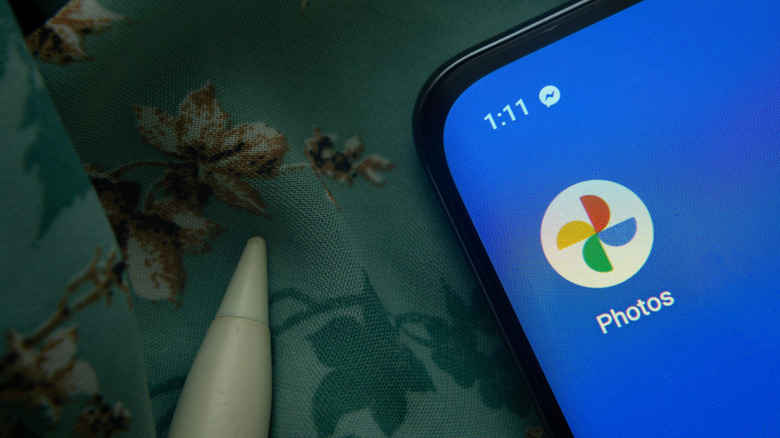 The Google Photos app icon is seen on a smartphone