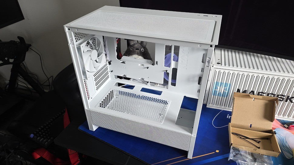 Here's the case we're starting with, the NZXT H3 Flow. You can see the extra cutouts that allow our backwards-facing ports to be accessible from the back side of the case. Please excuse Totoro, he's just very excited to be involved.
