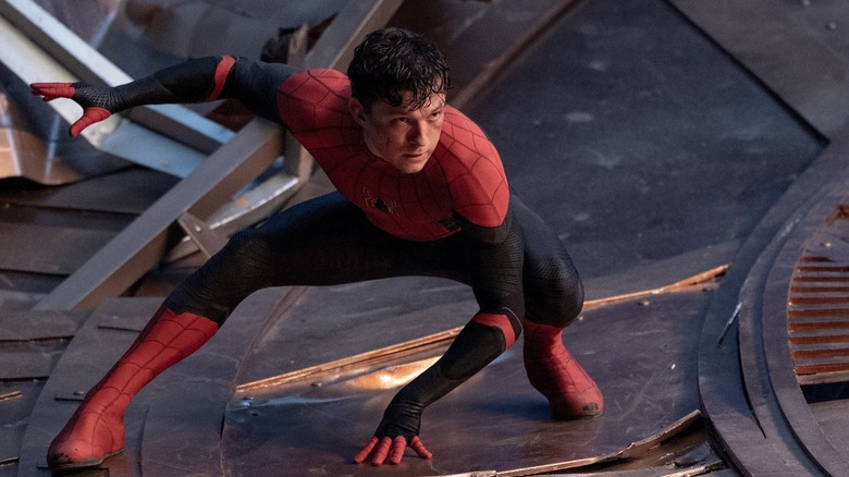 Spider-Man (Tom Holland) crouching on a building