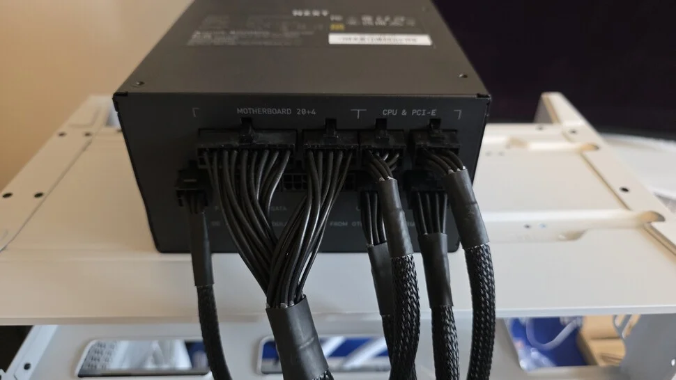 I find it easier to plug in the power cables we'll need while the PSU is outside of the case - in this case, the main motherboard connector, two CPU cables, two GPU cables and one SATA cable for the AiO and any SATA drives we add in the future.