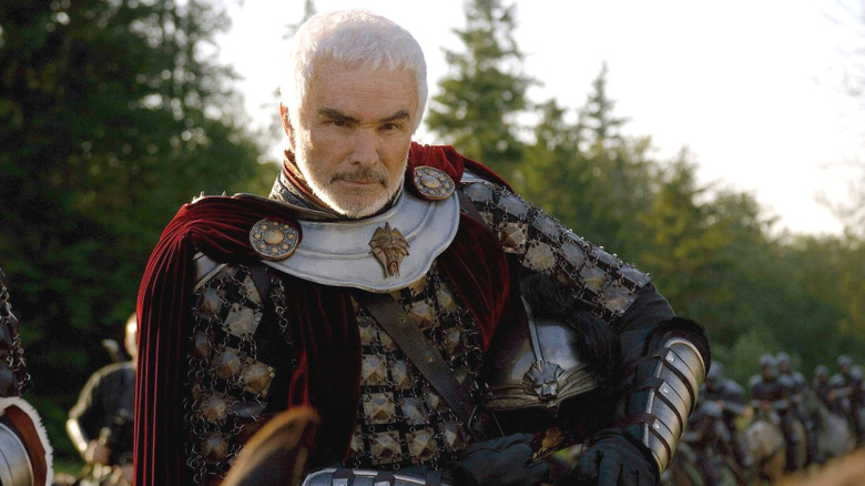 King Konreid looking serious while holdhing his helmet