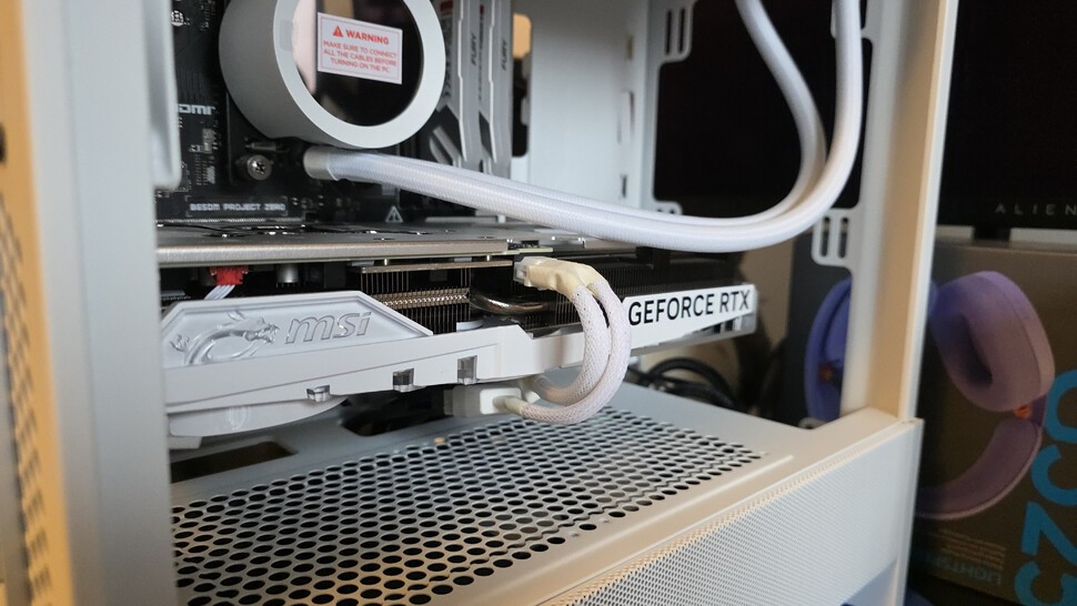 Installing the GPU is easy - just take out the matching PCIe covers on the left, then carefully angle the card into the top PCIe slot. Plug in the 12VHPWR cable, pushing until you hear a click. Secure the card with the screws you removed.