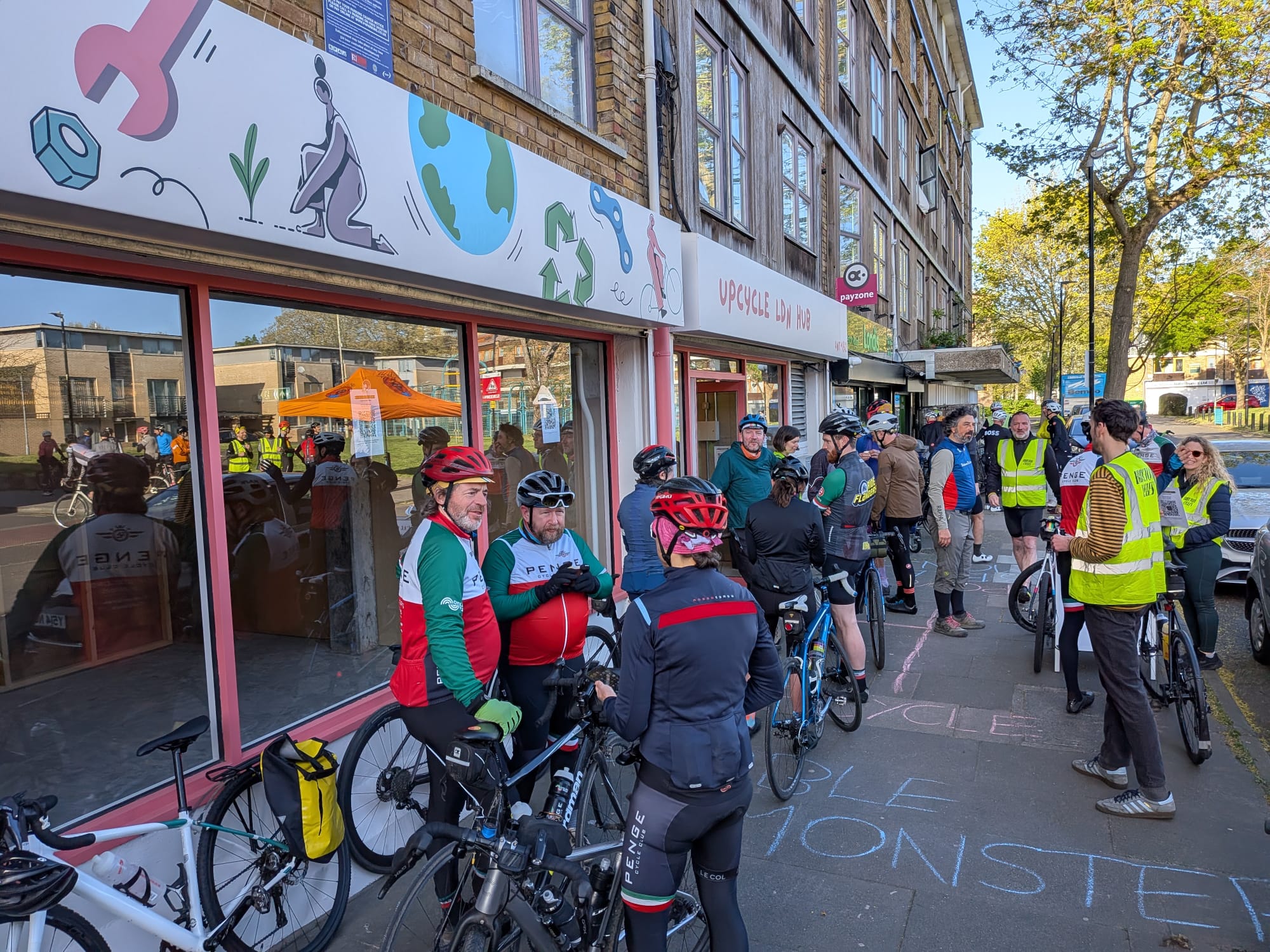 Group waits outside of a cafe with bikes