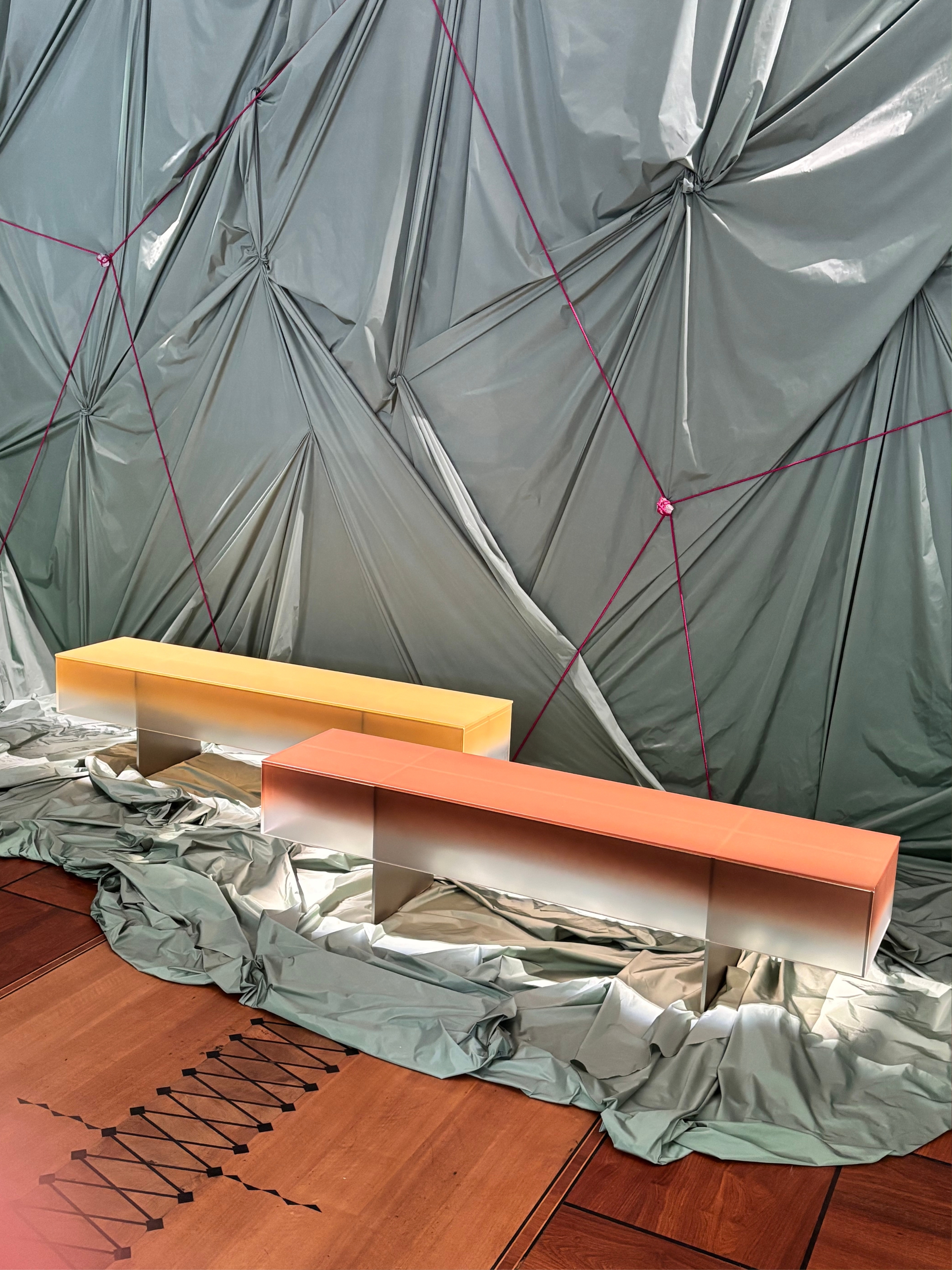 ombre glass tables in an exhibition at milan design week