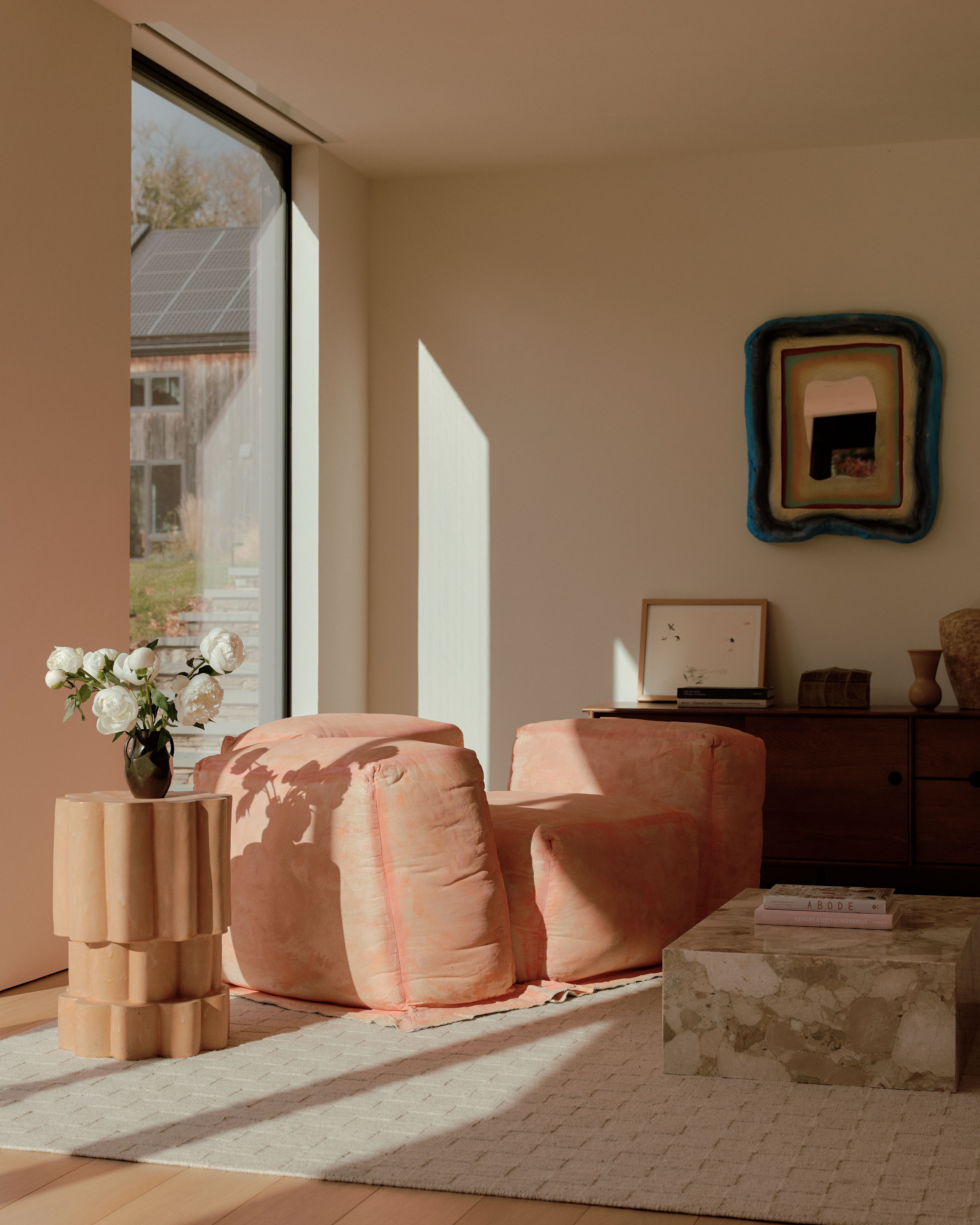 Living rooms with playful, sculptural designer piece and lots of natural light.