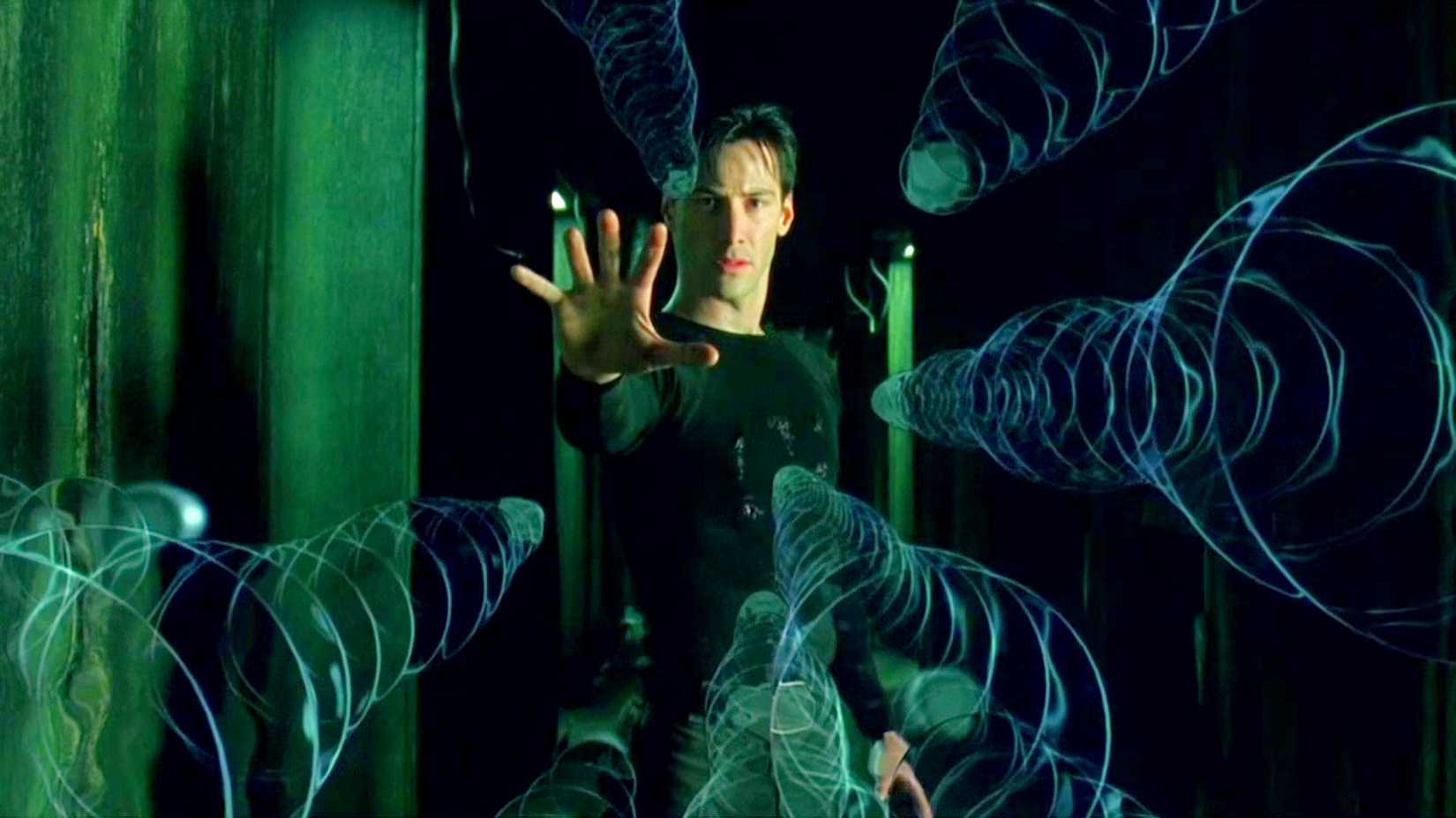 Keanu Reeves as Neo slowing down bullets in The Matrix