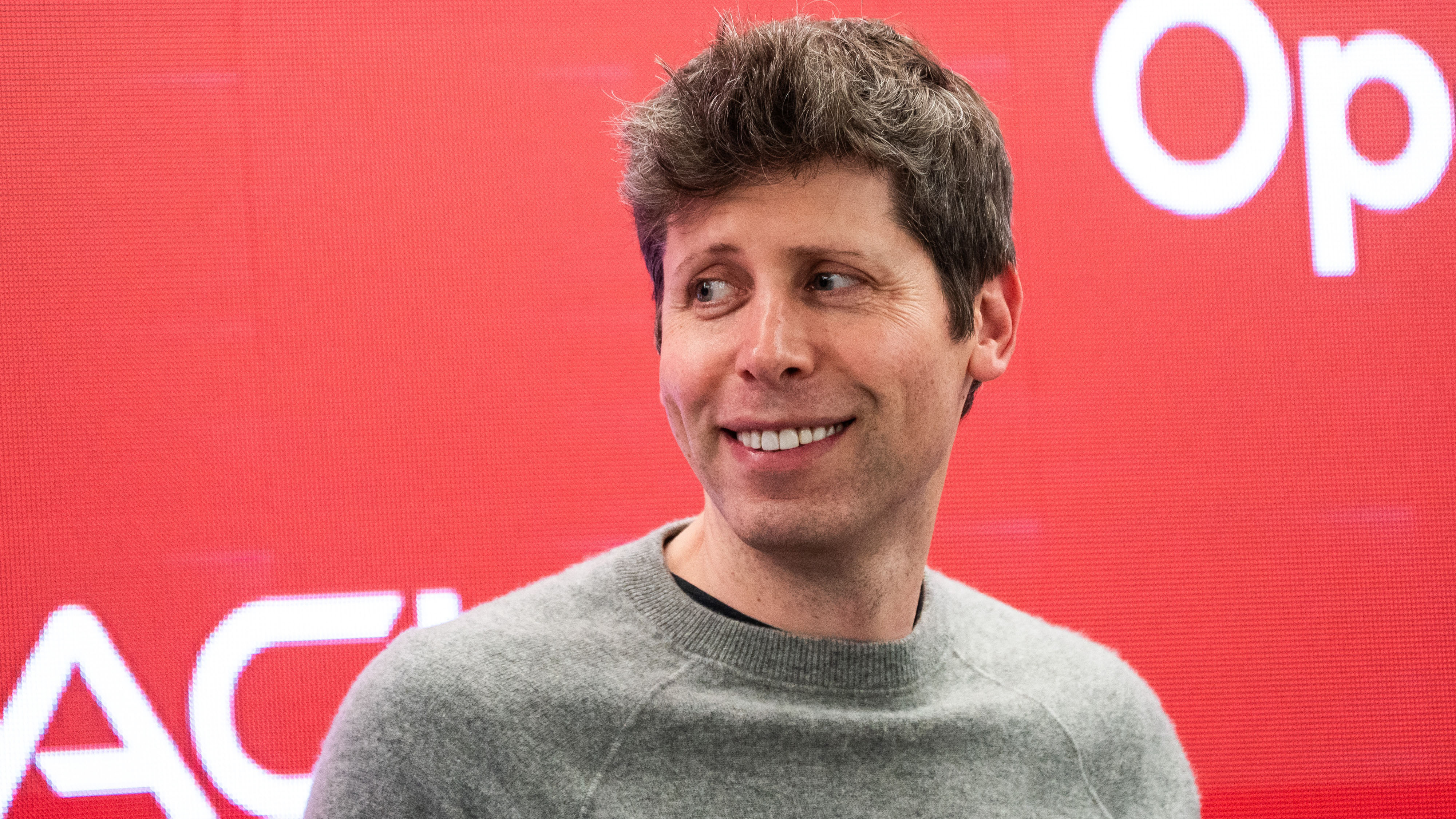 Sam Altman smiling.