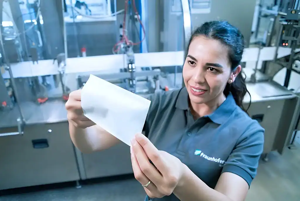 Laboratory technician examining a test paper in a science lab.