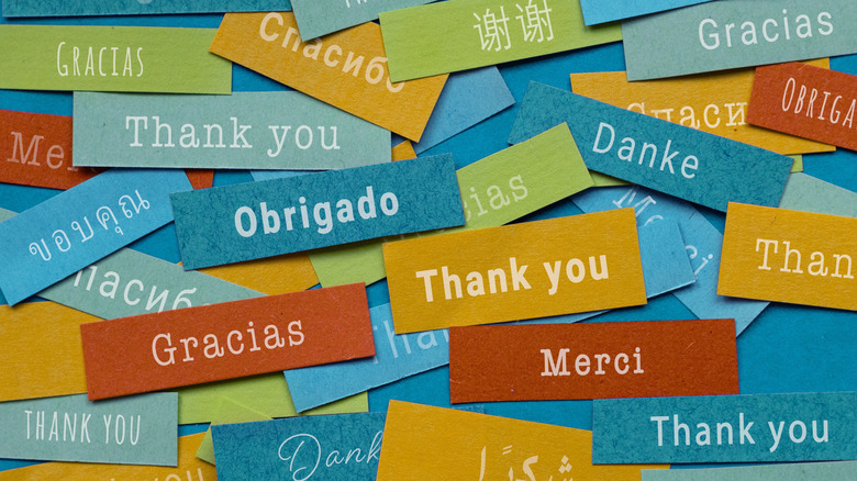 A pile of colorful tiles displaying the words thank you in different languages