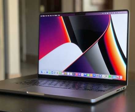 MacBook Pro 14 inch on a wooden desk