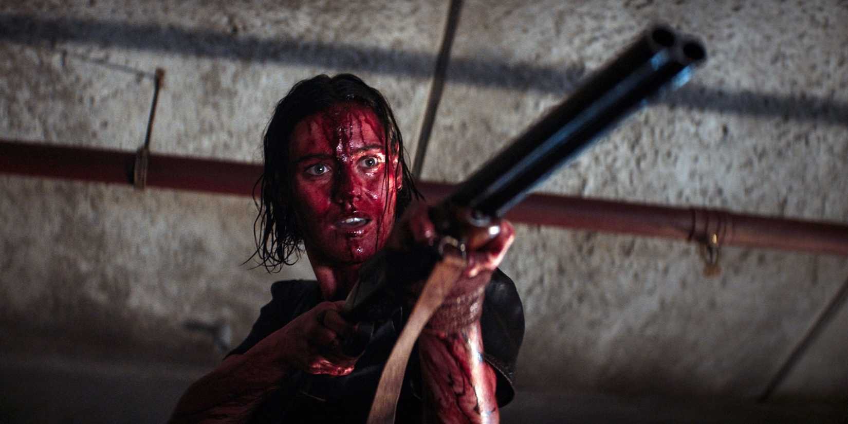 Lily Sullivan holding a gun in Evil Dead Rise.