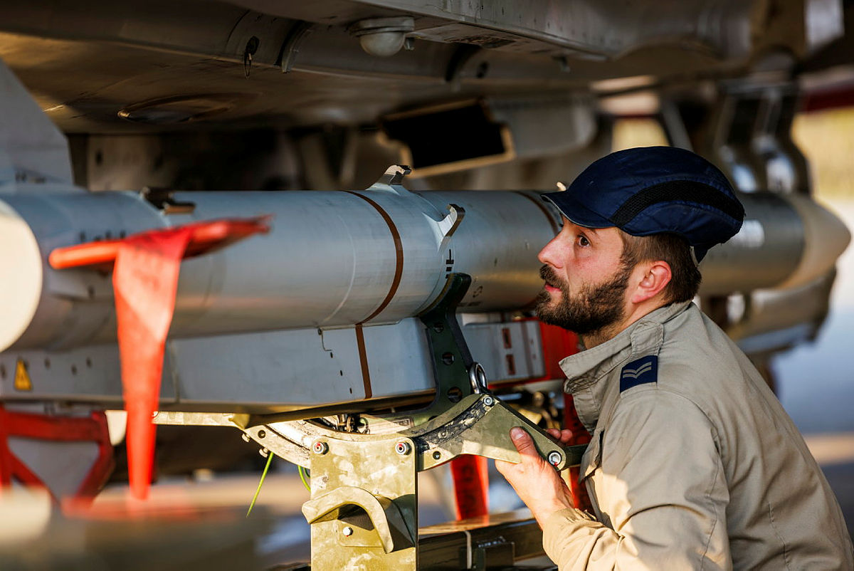 RAF armourers load a Meteor air-to-air missile from MBDA onto a Typhoon before a sortie in the Middle East.