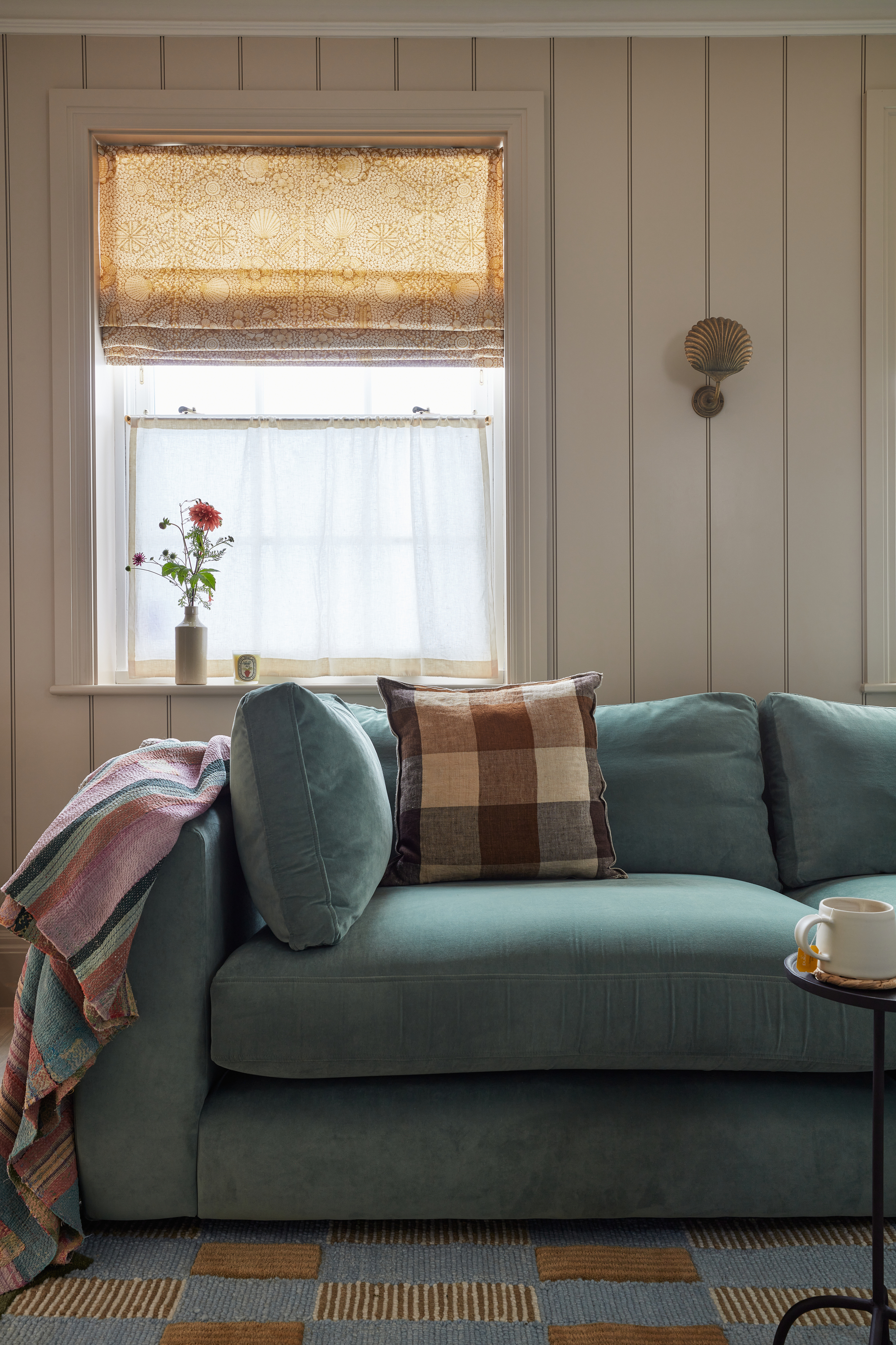 a cosy country-style living room with sheer cafe curtains