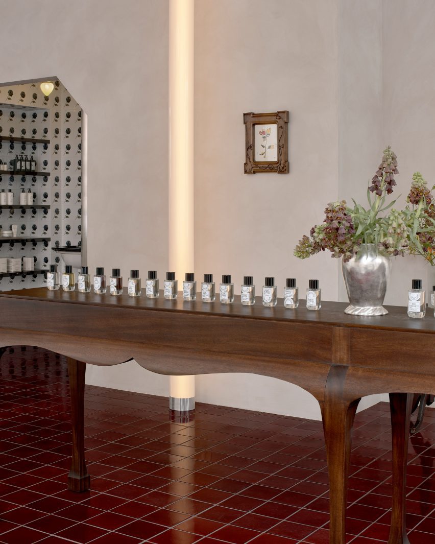 Perfume bottles displayed on a custom mahogany table