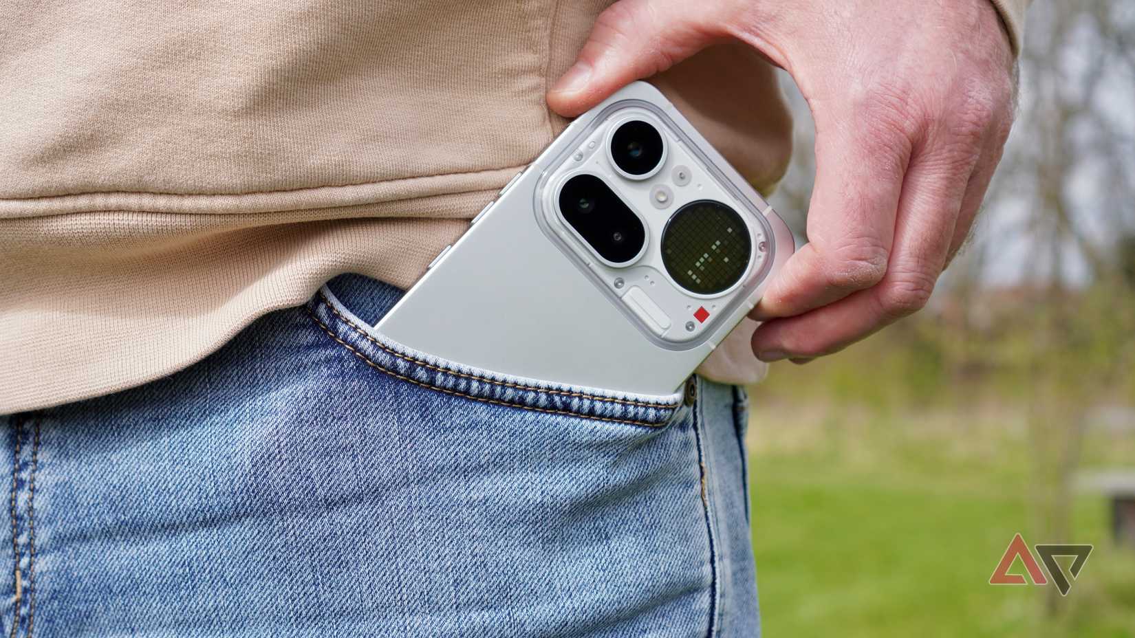 A person taking the Nothing Phone (4a) Pro out of a pocket