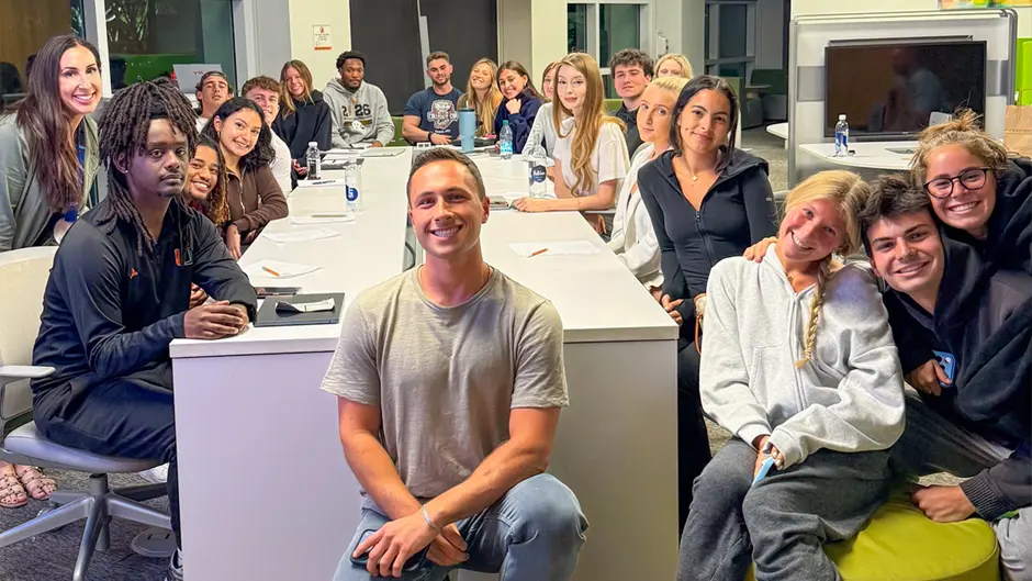 Rhonda Trust and her nutrition and communication class poses for a group photo with guest speaker Hunter Stoler, a certified health coach and content creator.