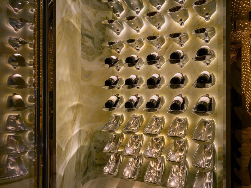 Bespoke stainless-steel wine bottle holders fill a display case