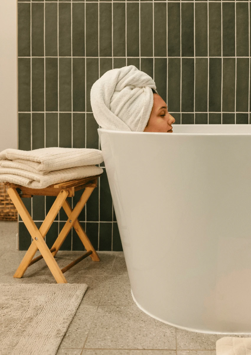 profile of woman sitting in a hot bath