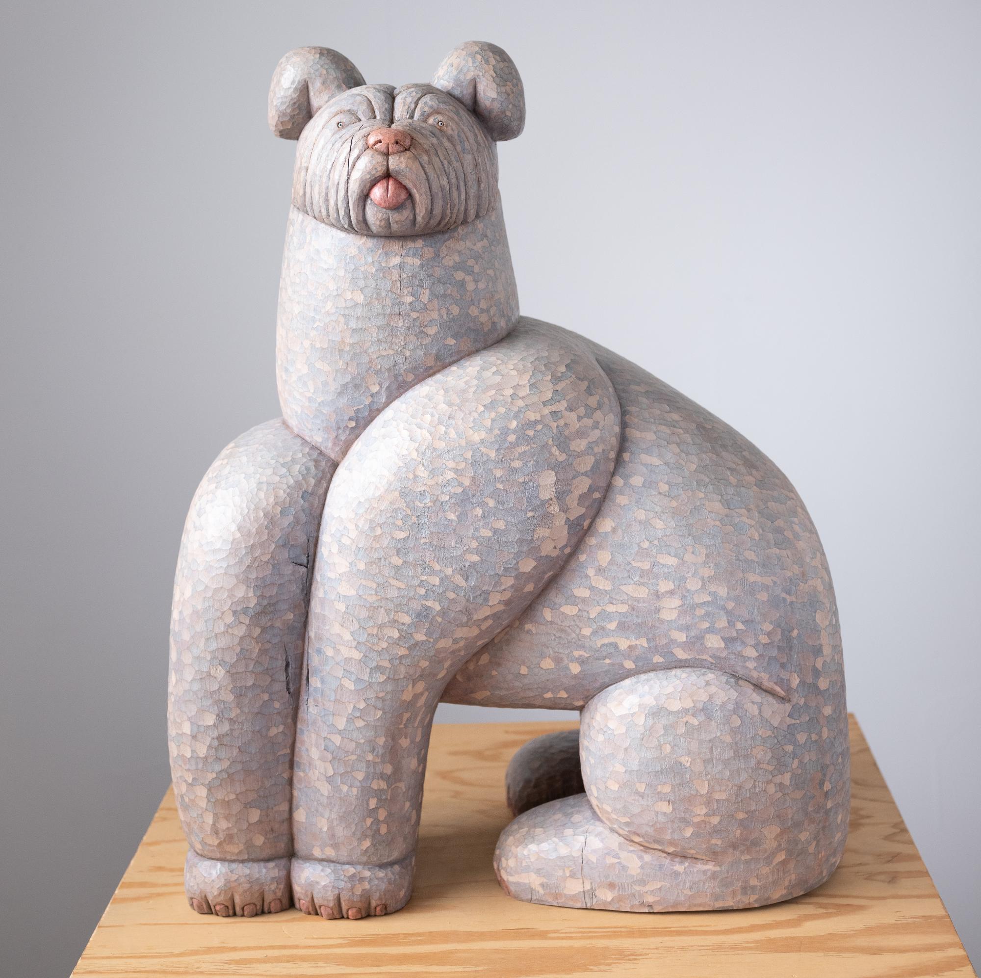 a wood-carved sculpture of a dog by Misato Sano