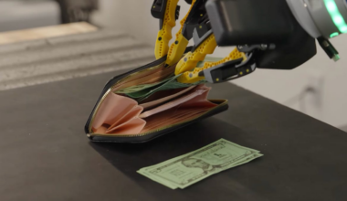 Robot hands putting money in wallet