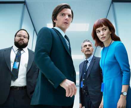 Four people in a hallway looking scared in Severance.