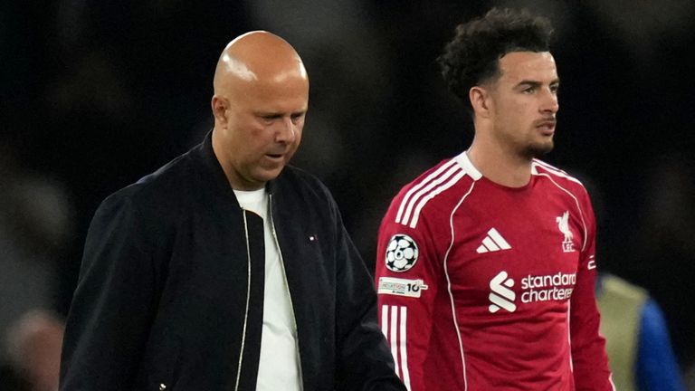 Arne Slot and Curtis Jones leave the field after Liverpool's 2-0 loss at PSG