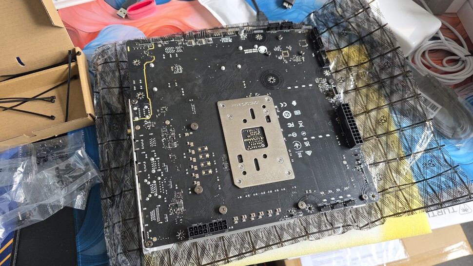 The back of the motherboard is where the magic happens - all of the power, front panel, fan and other connectors have been moved to this side.