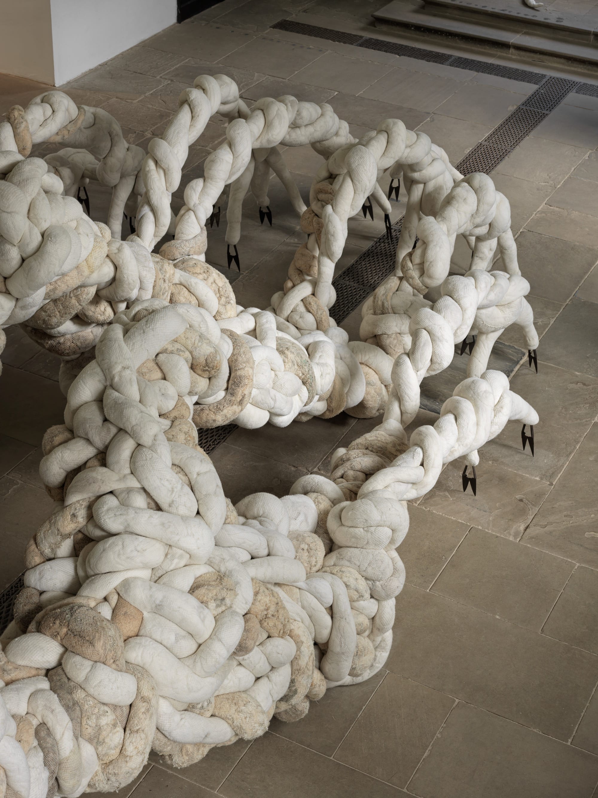 a detail of a large-scale textile installation by Nicola Turner with undulating, twisted details