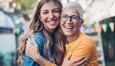Young investor and older investor smiling