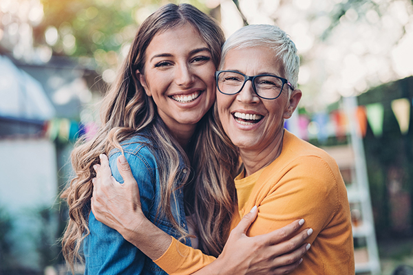 Young investor and older investor smiling