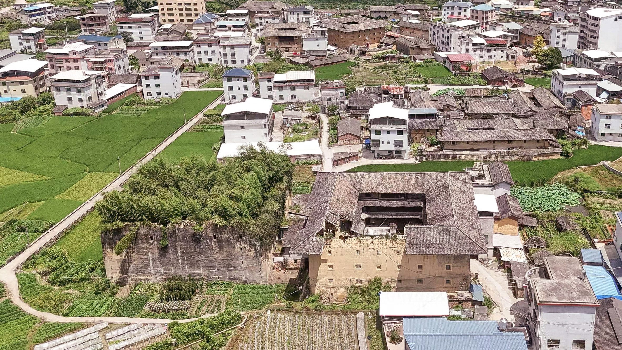 a photograph of buildings among green spaces