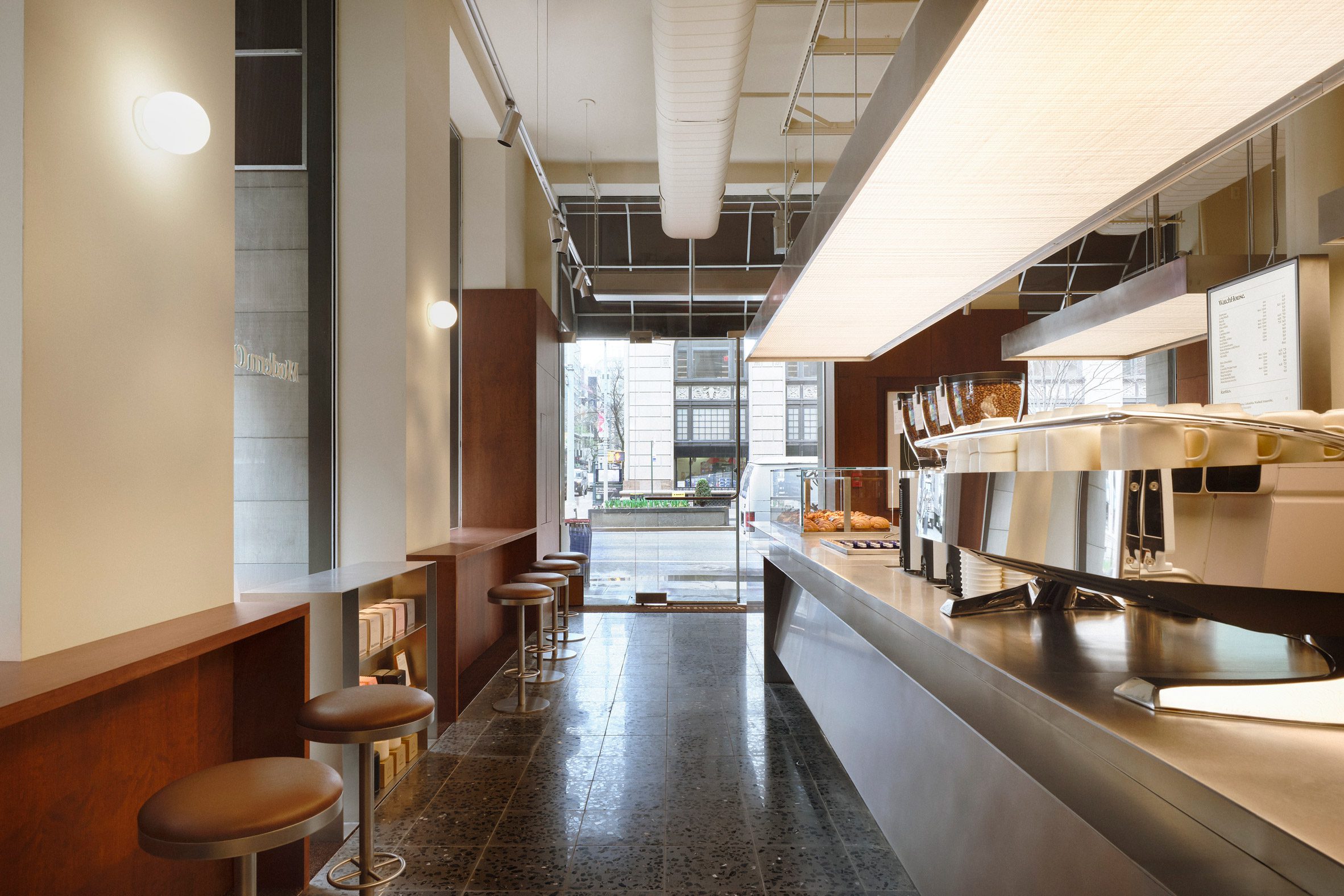 Large rectangular pendants suspended above polished steel cafe counters