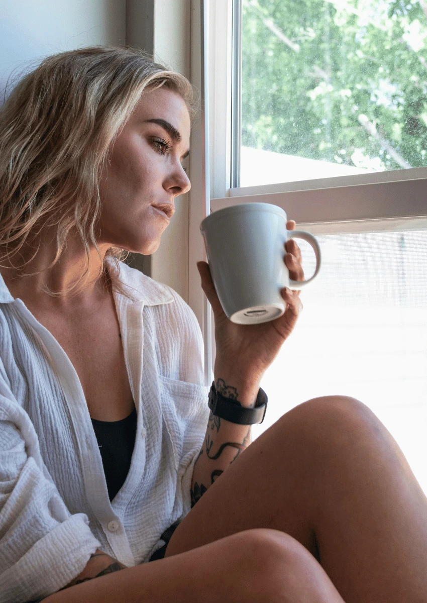 woman looking out of window losing track of time