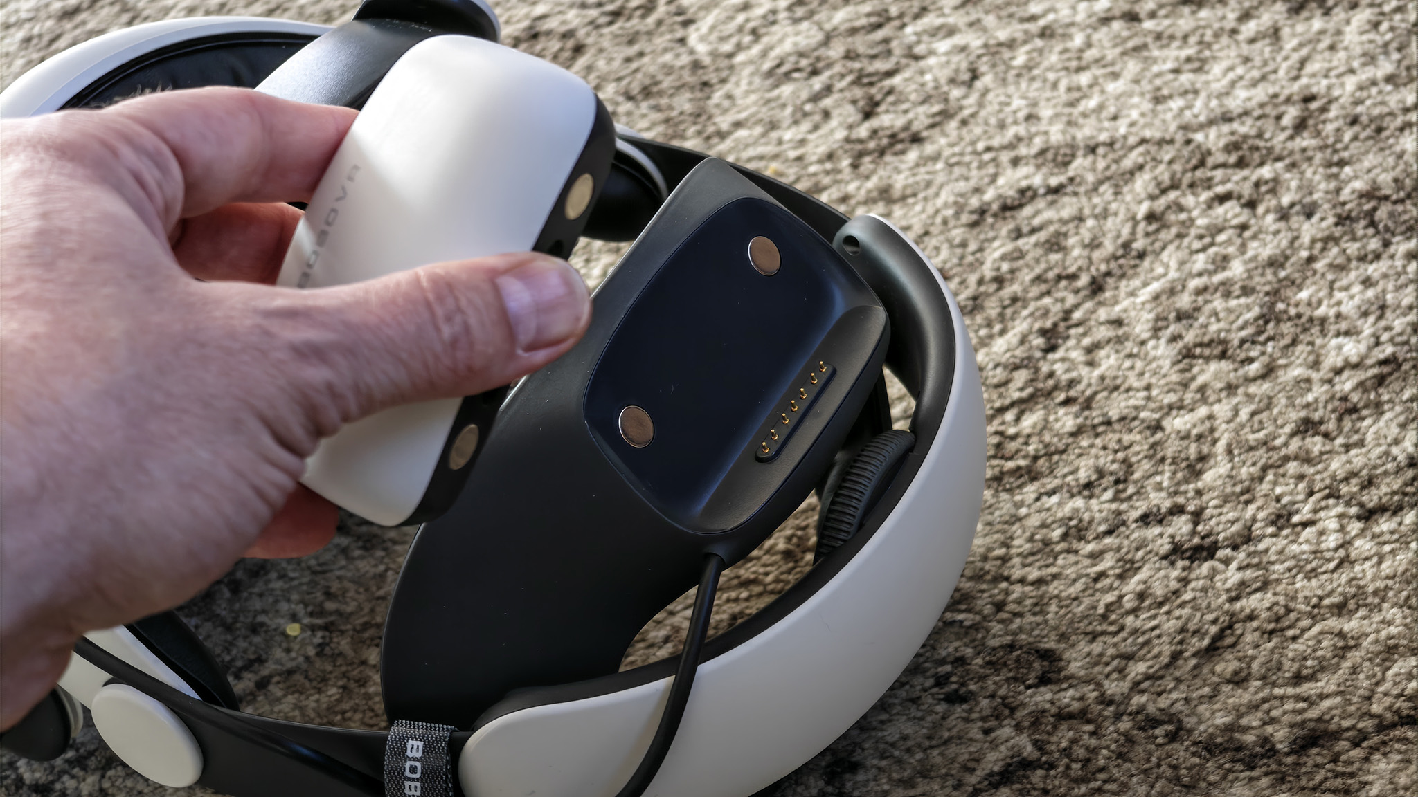 Detaching the magnetic battery on the back of a BoboVR S3 Pro installed on a Meta Quest 3 headset