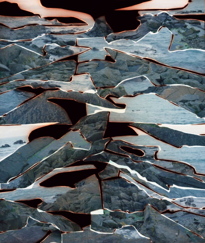 A rocky seashore photo appears fragmented and layered with jagged, torn edges and dark borders separating each piece, creating an abstract, collage-like effect over the ocean landscape.
