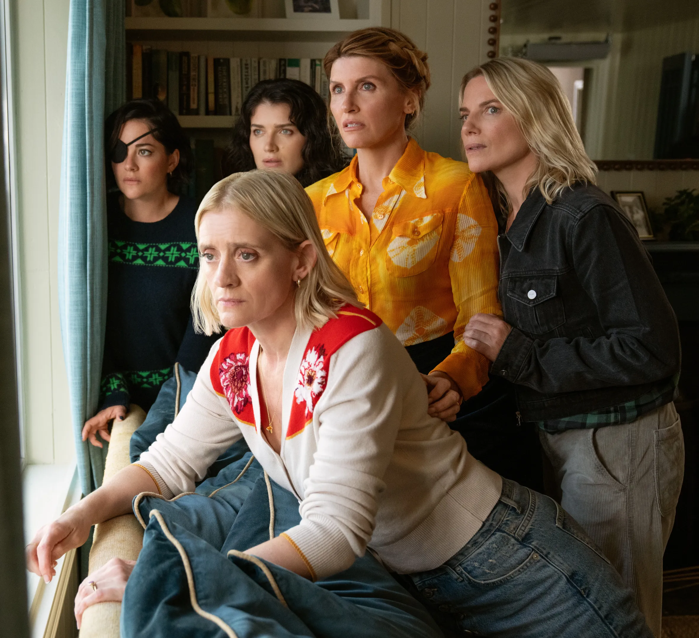 Five women, Anne-Marie Duff, Sarah Greene, Eve Hewson, Sharon Horgan and Eva Birthistle, looking out a window.