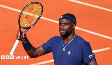 Frances Tiafoe raises his racquet at the French Open